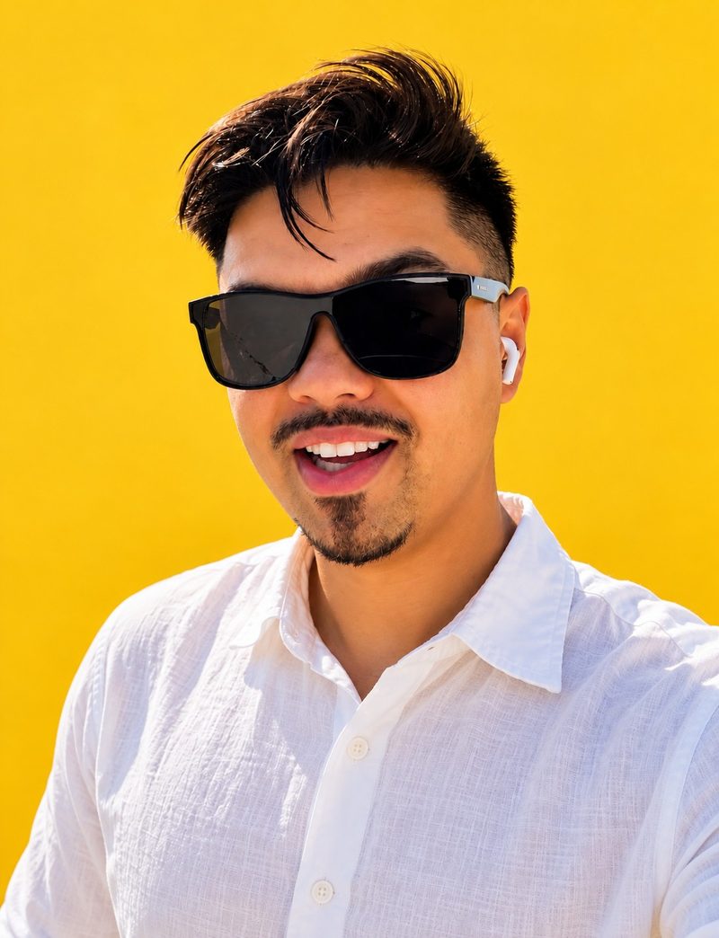 Jon, the founder of FunnelOnce, in sunglasses against a yellow wall